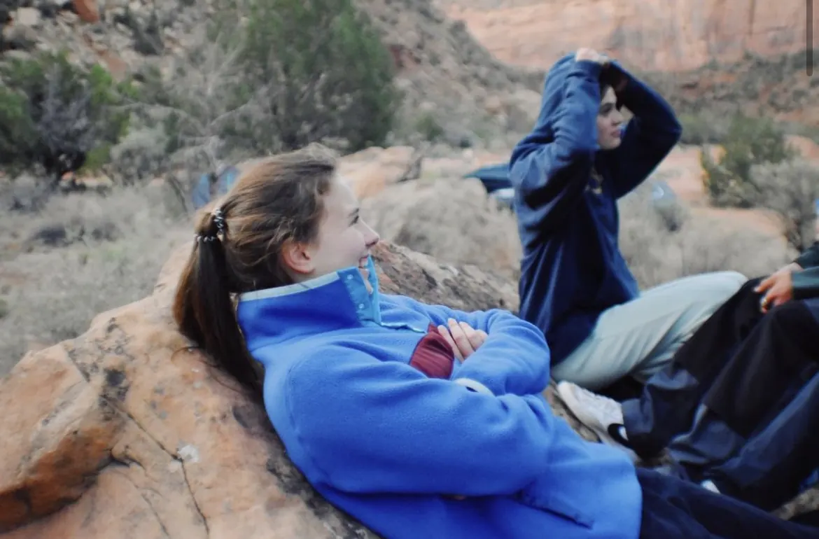 Two friends resting on red rocks